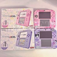 two pink and purple nintendo 3ds games consoles