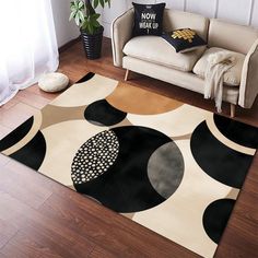 a living room area rug with black and white circles on it in front of a couch