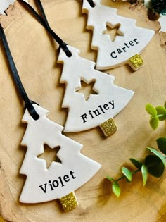 three wooden ornaments with different words on them