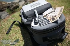 a piece of luggage sitting on top of a grass covered field