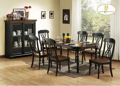 a dinning room table with chairs and a rug on the floor in front of it