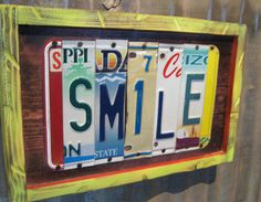 a wooden sign with the words smile on it