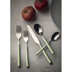 four forks, two spoons and an apple on a table