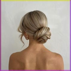 a woman with blonde hair in a low bun