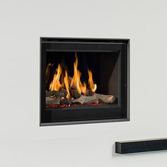 a wall mounted fireplace with fire burning in it