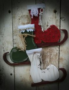 three snow shoes are sitting on top of a sled with red, green and white boots