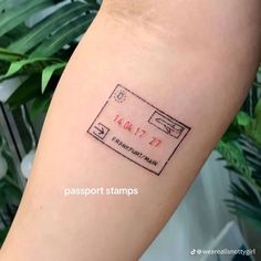 a passport stamp tattoo on the arm