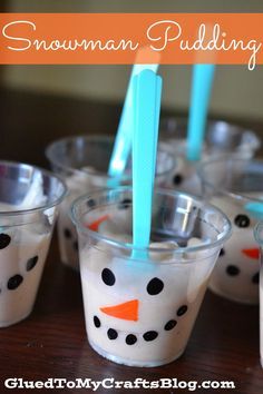 snowman pudding cups with toothbrushes in them sitting on a table next to each other