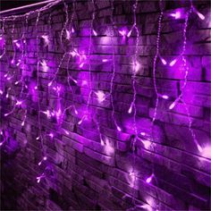 purple fairy lights on a brick wall