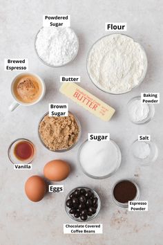 ingredients to make chocolate chip cookies laid out on a white counter top, including flour, butter, eggs, sugar, and other items