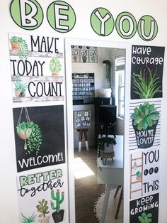 an office decorated with plants and sayings on the doors to its cubicle area