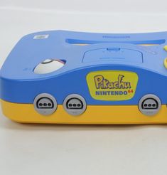 a blue and yellow nintendo wii game console sitting on top of a white countertop