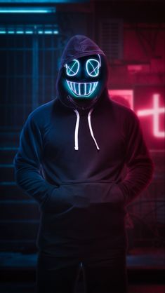 a man in a black hoodie with glowing eyes and a neon smile on his face