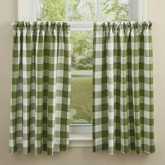 a green and white checkered curtain hanging on the side of a window sill