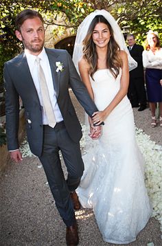 a bride and groom walking down the aisle