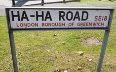 a street sign that is in the grass