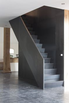 an empty room with stairs leading up to the second floor