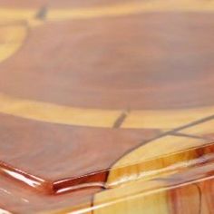 a close up view of the top of a wooden table with brown and yellow designs on it