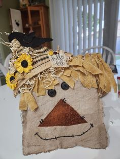 a scarecrow made out of burlap and fabric with sunflowers on it