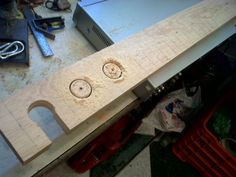 a kitchen counter top with two knobs on it and tools around the sink area