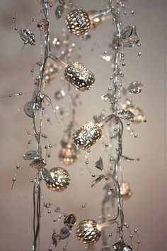 a christmas tree with ornaments hanging from it's branches and water droplets on the top