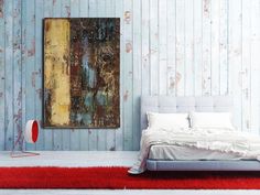 a bedroom with blue painted walls and a red rug on the floor next to a bed