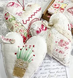 several heart shaped ornaments on top of papers