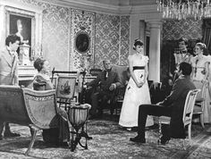 an old black and white photo of people in a living room