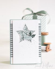 a card with a star on it next to some buttons and thread spools