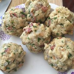 a white plate topped with meatballs covered in cheese