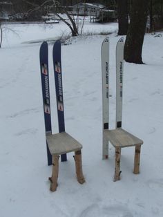 two wooden chairs made to look like skis in the snow