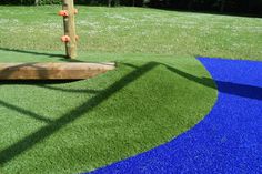 an artificial playground with blue and green grass