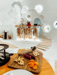 a wooden cutting board topped with food on top of a table