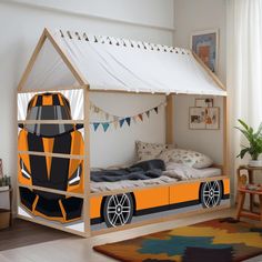 a child's bed with an orange car on it