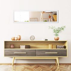 an empty room with a wooden shelf and potted plant on the sideboard in front of it