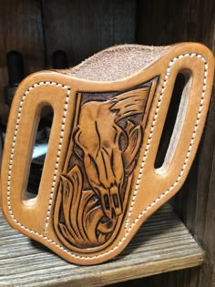 a close up of a leather object on a shelf