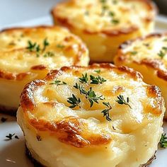 some food is on a white plate with green sprigs and parmesan cheese