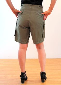 "These are amazing 1970s authentic vintage Dutch Army cargo shorts! Super rugged and cool, they feel like heavyweight smooth cotton and are classic military drab olive green, with four big cargo flap pockets that button. They have a five button fly front and adjustable button tabs on the sides of the waist. They are dated 1975 inside. The shorts are in good clean, freshly laundered, vintage condition. On the wearer's right side there are three buttons at the tab to adjust the waist size, and on Vintage Cotton Cargo Shorts With Pockets, Retro Cotton Cargo Bottoms, Retro Short Leg Bottoms With Pockets, Retro Bottoms With Pockets And Short Legs, Vintage Cotton Khaki Shorts, Vintage Cotton Shorts With Cargo Pockets, Vintage Cargo Bottoms For Summer, Vintage Cotton Cargo Shorts For Summer, Vintage Khaki Short Bottoms