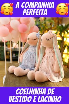 two stuffed animals sitting next to each other on a table with balloons in the background