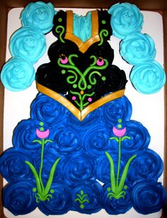 the cake is decorated with blue icing and flowers