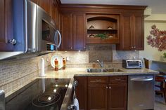 a kitchen with wooden cabinets and stainless steel appliances