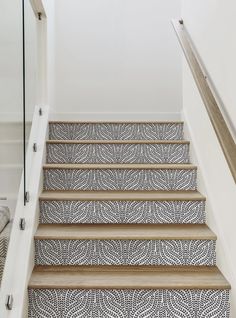 the stairs are decorated with black and white tiles