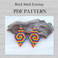 a pair of colorful earrings sitting on top of a piece of drift wood with text overlay that reads, brick stitch earrings pdf pattern