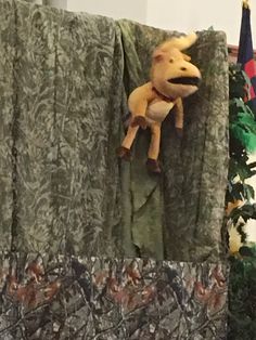 a stuffed animal hanging on the side of a curtain