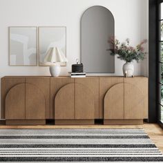 a living room scene with focus on the sideboard and large mirror in the background