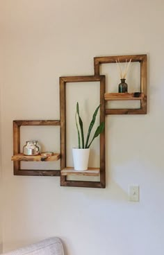 three square wooden shelves with plants in them