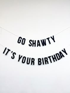 two black letters that say go shawty it's your birthday hanging on a string