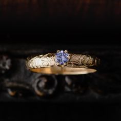 a close up of a ring with a blue stone on it's center piece