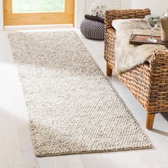 a living room with wicker chairs and rugs