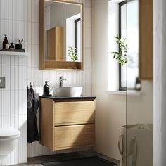 a bathroom with a sink, mirror and toilet